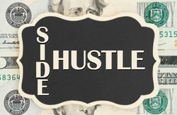 Making money with your side hustle, Side Hustle text on chalkboard on USA twenty dollar bills