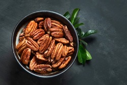 Pecan nuts in bowl. Top view with copy space
