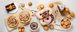 Desserts assortment on light background. Freshly made bakery and treats. Flat lay, top view, panorama