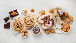 Desserts assortment on light background. Freshly made bakery and treats. Flat lay, top view