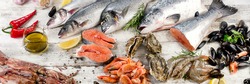 Fresh fish and other seafood on wooden background. Top view