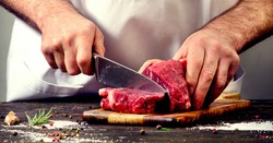 Man cutting beef meat.
