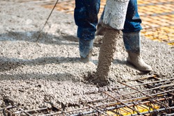 pouring cement or concrete into slabs layers of new house. Construction site details