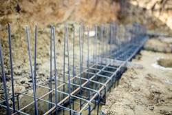 Foundation site of new building, details and reinforcements with steel bars and wire rod, preparing for cement pouring