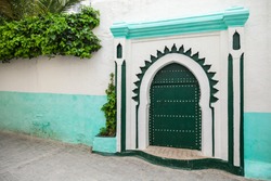 Green wooden gate of ancient mosque in Medina. Tangier, Morocco