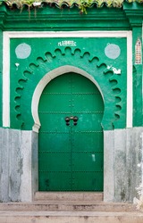 Green gate of ancient mosque in Medina. Tangier, Morocco