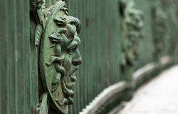 Decorative fence of the Summer Garden, built in 1825, St.Petersburg, Russia. Medusa face. In Greek mythology it was a monster, Gorgon, winged human female with living venomous snakes in place of hair