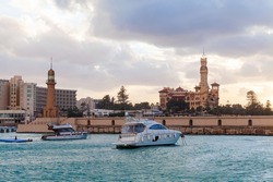 Montazah beach view, Montazah palace and lighthouse tower are under colorful cloudy sky, Alexandria, Egypt