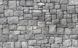 Old gray stone wall, seamless background photo texture