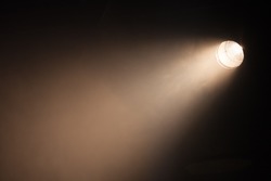 Ray of scenic spot light over dark background, stage illumination equipment