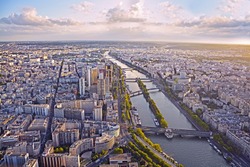 Aerial view of Paris and Seine river from Eiffel tower at sunset.