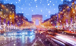Arch of Triumph and Champs Elysees in Paris at Christmas snowy night, France.