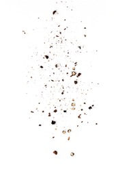 Sifting heavy ground black pepper over white background.