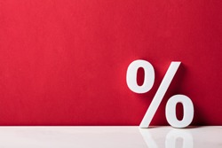 Close-up Of A Percentage Sign Leaning On Red Wall