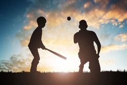 Silhouette Of Boy Playing Baseball With His Father At Sunset