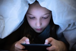 Girl Under White Blanket Using Digital Tablet