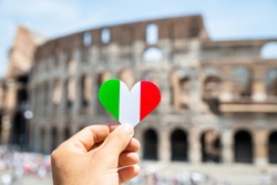 Woman Holding Heart Shaped Italian Flag In Front Of Colosseum, Italy