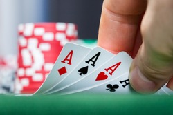 Close-up of a poker player holding playing cards