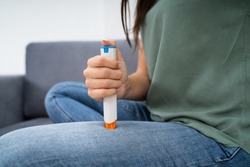 Woman Injecting Epinephrine Using Auto-injector Syringe As An Emergency Treatment For Allergic Reaction