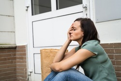 Young Woman Waiting In Front Of Closed Door