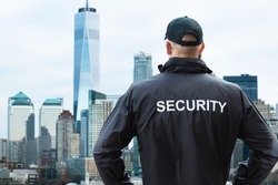 Male Security Guard Looking At City Skyline In Manhattan, New York