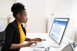 African Woman Filling Survey Poll Or Form On Desktop Computer