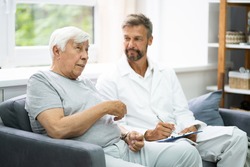 Home Care Elder Patient Talking To His Doctor