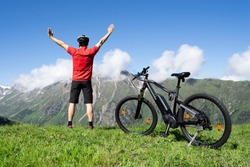 E Bike Mountain Bicycle In Austria. Excited Man With Ebike 