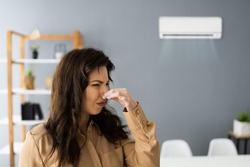 Air Conditioner Odor At Home. Upset Woman