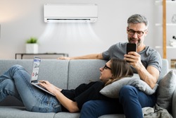 Happy Family Using Air Condition In House