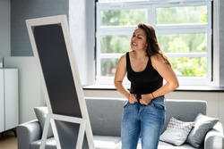 Woman Struggling With Tight Jeans. Weight Gain