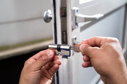Locksmith Lock Door Repair. Worker Changing And Cylinder
