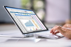 Electronic Spreadsheet Analyst Or Auditor Using Software On Hybrid Laptop