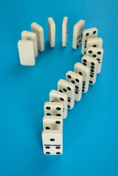 Close-up Of A Question Mark Made From Domino On Blue Background