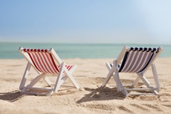 Photo Of Two Miniature Deckchairs On Sunny Beach