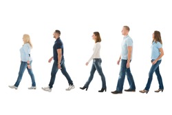 Full length side view of men and women walking in queue isolated on white background