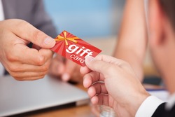 Person Giving Gift Card