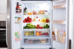 Open Refrigerator Filled With Fresh Fruits And Vegetable