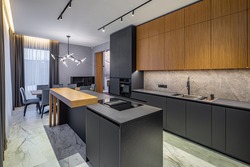 Modern interior of kitchen in luxury private house. Grey and wooden design. Marble floor. Panorama windows. Stylish kitchen set.