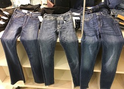 Clothes,jeans  on hangers in a retail shop

