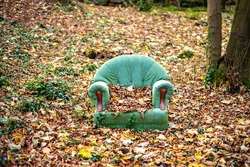 Abandoned chair in autumn forest 