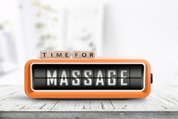 Time for massage message on a retro clock in a bright room on a white desk