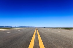 highway in steppe against a blue sky,long road stretching out into the distance