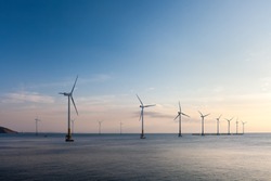 offshore wind farm at dusk, renewable energy background