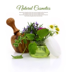 Wooden mortar and cosmetic cream jar with herbs inside