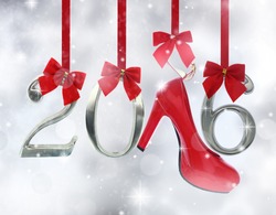 High heel shoe and 2016 number hanging on red ribbons in a glittery background