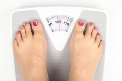 Bathroom scale. Obese Woman' s feet 