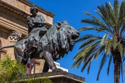 19th century bronze statue representing the Lyric seated on a lion by Sir Mario Rutelli, located next to the Massimo Theater's entrance staircase in Palermo, Sicily.