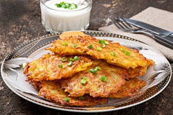Fried potato pancakes on the old wooden background