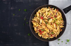 Conchiglie pasta. Italian pasta shells with minced meat, zucchini, tomato and sweet peppers. Top view, above